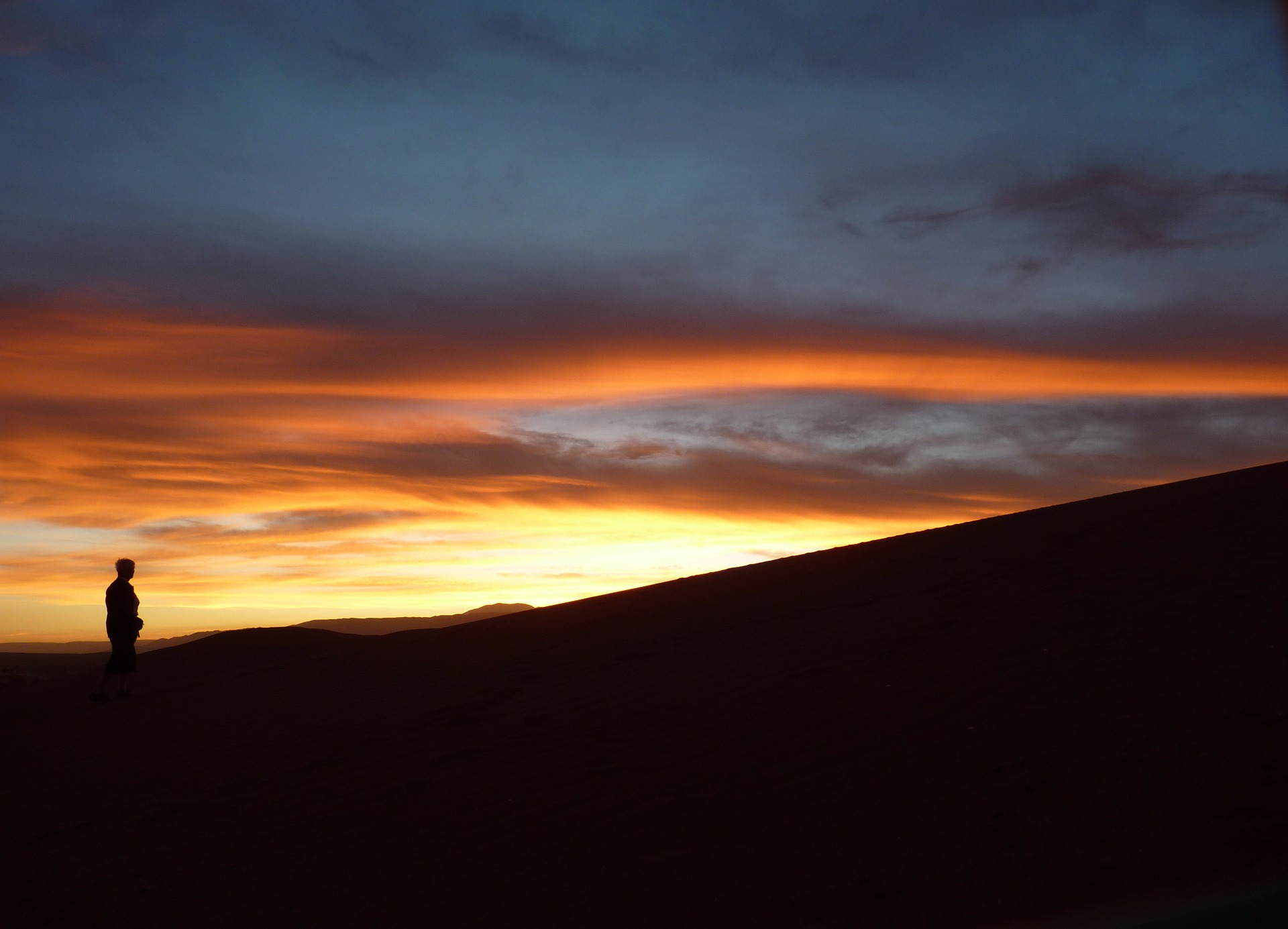 Mountain-top sunset with silhouetted man